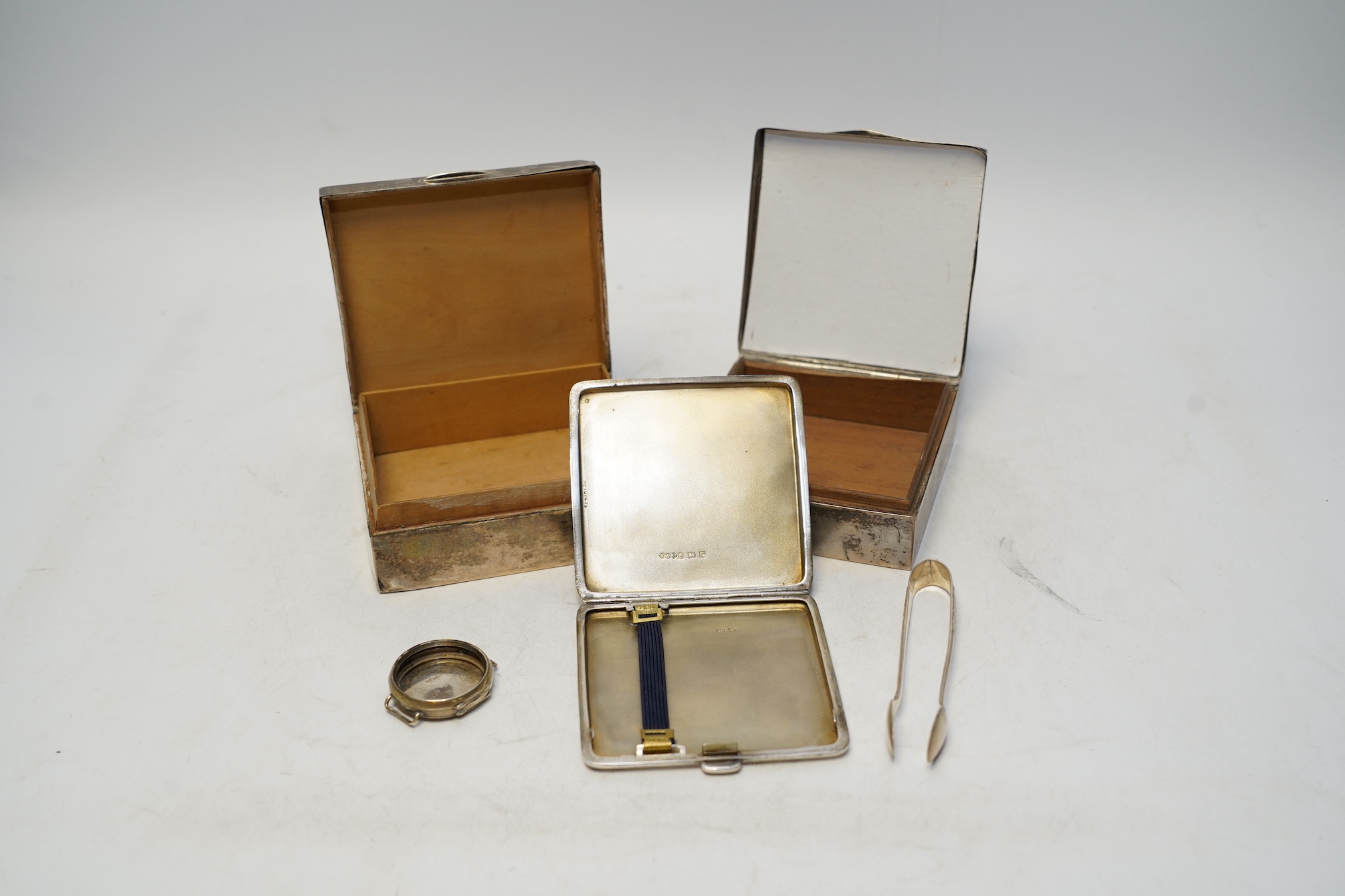 Two early 20th century silver mounted square cigarette boxes, largest 10.1cm, a similar silver cigarette case and three other silver items. Condition - fair to poor